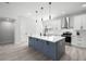 Modern kitchen with gray island, white cabinets, stainless steel appliances, and hardwood flooring at 4120 W North A St # 2, Tampa, FL 33609