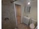 Bathroom featuring tiled shower, single sink vanity, and neutral wall and floor tiles at 4607 N 35Th St, Tampa, FL 33610
