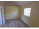 Bedroom featuring tiled floors, neutral walls, a window offering natural light, and closet space at 4607 N 35Th St, Tampa, FL 33610