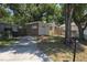 Single-story home featuring brick accents, a driveway, and mature trees at 4607 N 35Th St, Tampa, FL 33610