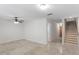 Spacious basement area with tile flooring, modern lighting fixtures, and convenient access to stairs at 512 S Glen Ave, Tampa, FL 33609