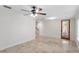 Bright basement area features modern lighting, tile flooring, and access to stairs and a door to the exterior at 512 S Glen Ave, Tampa, FL 33609