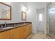 Bathroom with a double sink vanity, walk-in shower and nice tile flooring at 512 S Glen Ave, Tampa, FL 33609