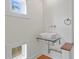 Modern bathroom with wood floors, wall-mounted faucet over glass sink, and ample natural light at 512 S Glen Ave, Tampa, FL 33609