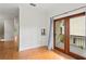 Bedroom featuring french doors to a balcony with hardwood floors and neutral walls at 512 S Glen Ave, Tampa, FL 33609