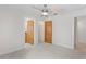 Spacious bedroom featuring two wooden doors, neutral paint, crown molding, and a ceiling fan at 512 S Glen Ave, Tampa, FL 33609