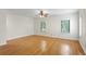 Bright bedroom with hardwood floors, ceiling fan, and large windows at 512 S Glen Ave, Tampa, FL 33609