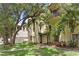Inviting exterior view of a multi-story home with lush landscaping and a charming front entrance with tropical greenery at 512 S Glen Ave, Tampa, FL 33609