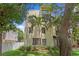 Multi-story home facade framed by trees, with palm tree, grass lawn and an inviting exterior at 512 S Glen Ave, Tampa, FL 33609