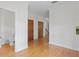 Hallway with wooden floors, neutral walls, crown molding, and three wooden closet doors at 512 S Glen Ave, Tampa, FL 33609