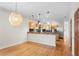Bright, open kitchen with stainless steel appliances and modern pendant lighting at 512 S Glen Ave, Tampa, FL 33609