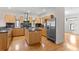 Modern kitchen with a center island, stainless steel appliances, and beautiful hardwood floors at 512 S Glen Ave, Tampa, FL 33609