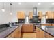 Well-equipped kitchen boasts stainless steel appliances, granite countertops, wood cabinetry, and ample counter space at 512 S Glen Ave, Tampa, FL 33609