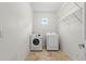 Laundry room with side-by-side washer and dryer, upper wire shelving, and natural light at 512 S Glen Ave, Tampa, FL 33609