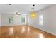 Bright living room with hardwood floors, ceiling fan, and large windows at 512 S Glen Ave, Tampa, FL 33609