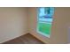 Bright bedroom with carpeted floors and a large window at 5407 Kedgewick Ln, North Port, FL 34288