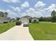 Charming single-story home with a well-manicured lawn and paved driveway at 5407 Kedgewick Ln, North Port, FL 34288