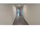 Long hallway with sleek floors, offering ample space to get from room to room at 5407 Kedgewick Ln, North Port, FL 34288