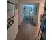 Bright hallway with wood-look floors leads to front door at 5407 Kedgewick Ln, North Port, FL 34288