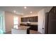 Modern kitchen featuring stainless steel appliances and a granite island at 5407 Kedgewick Ln, North Port, FL 34288