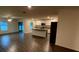 Spacious living room with wood floors adjacent to an island kitchen at 5407 Kedgewick Ln, North Port, FL 34288