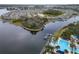 Expansive waterfront community with lush landscaping surrounding a serene lake and community pool at 5413 Wishing Arch Dr, Apollo Beach, FL 33572