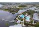 Aerial view showing the lakefront community pool and clubhouse surrounded by lush landscaping at 5413 Wishing Arch Dr, Apollo Beach, FL 33572