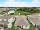 Expansive home featuring lush landscaping and a serene backyard setting with mature trees and a lake at 5413 Wishing Arch Dr, Apollo Beach, FL 33572