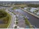 Aerial view of a residential area with waterfront homes along a winding canal, boats docked at each property at 5413 Wishing Arch Dr, Apollo Beach, FL 33572