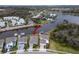Aerial view of a waterfront home, featuring a private boat dock and stunning water views at 5413 Wishing Arch Dr, Apollo Beach, FL 33572
