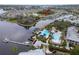 Overhead view showcasing the community pool, lush landscaping, and surrounding waterfront properties at 5413 Wishing Arch Dr, Apollo Beach, FL 33572