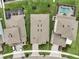 Overhead view of three houses and a pool, showcasing the backyard of a waterfront property at 5413 Wishing Arch Dr, Apollo Beach, FL 33572
