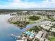Panoramic aerial view showcasing waterfront homes, a community pool, and stunning water views at 5413 Wishing Arch Dr, Apollo Beach, FL 33572