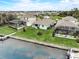 A waterfront home features a pier, lush landscaping, and serene water views, perfect for outdoor living at 5413 Wishing Arch Dr, Apollo Beach, FL 33572