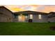 Backyard view with covered patio, white railing, and grill overlooking a green lawn at 5413 Wishing Arch Dr, Apollo Beach, FL 33572