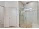 Bathroom showcasing a glass-enclosed shower with pebble flooring and tiled walls at 5413 Wishing Arch Dr, Apollo Beach, FL 33572