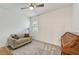 Bright bedroom features neutral walls, carpet, a comfortable sofa and ceiling fan at 5413 Wishing Arch Dr, Apollo Beach, FL 33572