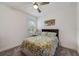 Cozy bedroom featuring a ceiling fan, neutral paint, carpeted floors, and natural lighting at 5413 Wishing Arch Dr, Apollo Beach, FL 33572