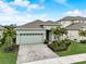 Charming single-Gathering home featuring manicured lawn, beautiful landscaping, and a welcoming two-car garage at 5413 Wishing Arch Dr, Apollo Beach, FL 33572