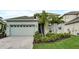 Charming home featuring a beautiful front yard, lush landscaping, and a welcoming entrance at 5413 Wishing Arch Dr, Apollo Beach, FL 33572
