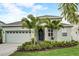 Charming home featuring a beautiful front yard, lush landscaping, and a welcoming entrance at 5413 Wishing Arch Dr, Apollo Beach, FL 33572