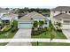 Charming single-Gathering home with a 2 car garage, a paved driveway, and tropical landscaping at 5413 Wishing Arch Dr, Apollo Beach, FL 33572
