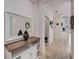 Hallway with stylish decor including a mirror, console table, and decorative wall art at 5413 Wishing Arch Dr, Apollo Beach, FL 33572