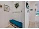 Hallway features built-in bench with cubbies, coat hooks, and decorative wall art at 5413 Wishing Arch Dr, Apollo Beach, FL 33572