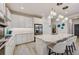 Bright kitchen with island seating, pendant lights, and stainless steel appliances at 5413 Wishing Arch Dr, Apollo Beach, FL 33572