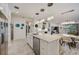 Bright kitchen with granite island, stainless steel appliances, and views of the dining area at 5413 Wishing Arch Dr, Apollo Beach, FL 33572