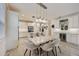 Open-concept kitchen and dining area featuring modern lighting and an elegant dining table at 5413 Wishing Arch Dr, Apollo Beach, FL 33572