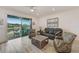 Spacious living room with access to an outdoor patio overlooking the waterfront at 5413 Wishing Arch Dr, Apollo Beach, FL 33572