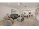 Comfortable living room with tiled floors, sofa, armchairs, and an open view to the kitchen at 5413 Wishing Arch Dr, Apollo Beach, FL 33572