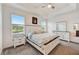 Bright main bedroom boasting serene lake views from large windows at 5413 Wishing Arch Dr, Apollo Beach, FL 33572